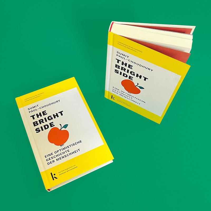 Buchcover von 'Sumit Paul-Choudhury - The Bright Side - Optimismus' mit gelbem Rand und rotem Apfel auf grünem Hintergrund. Kategorie: Bücher.